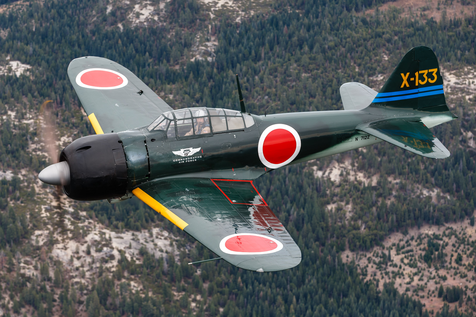 A6M3 Mitsubishi Zero flying against a California mountain range.